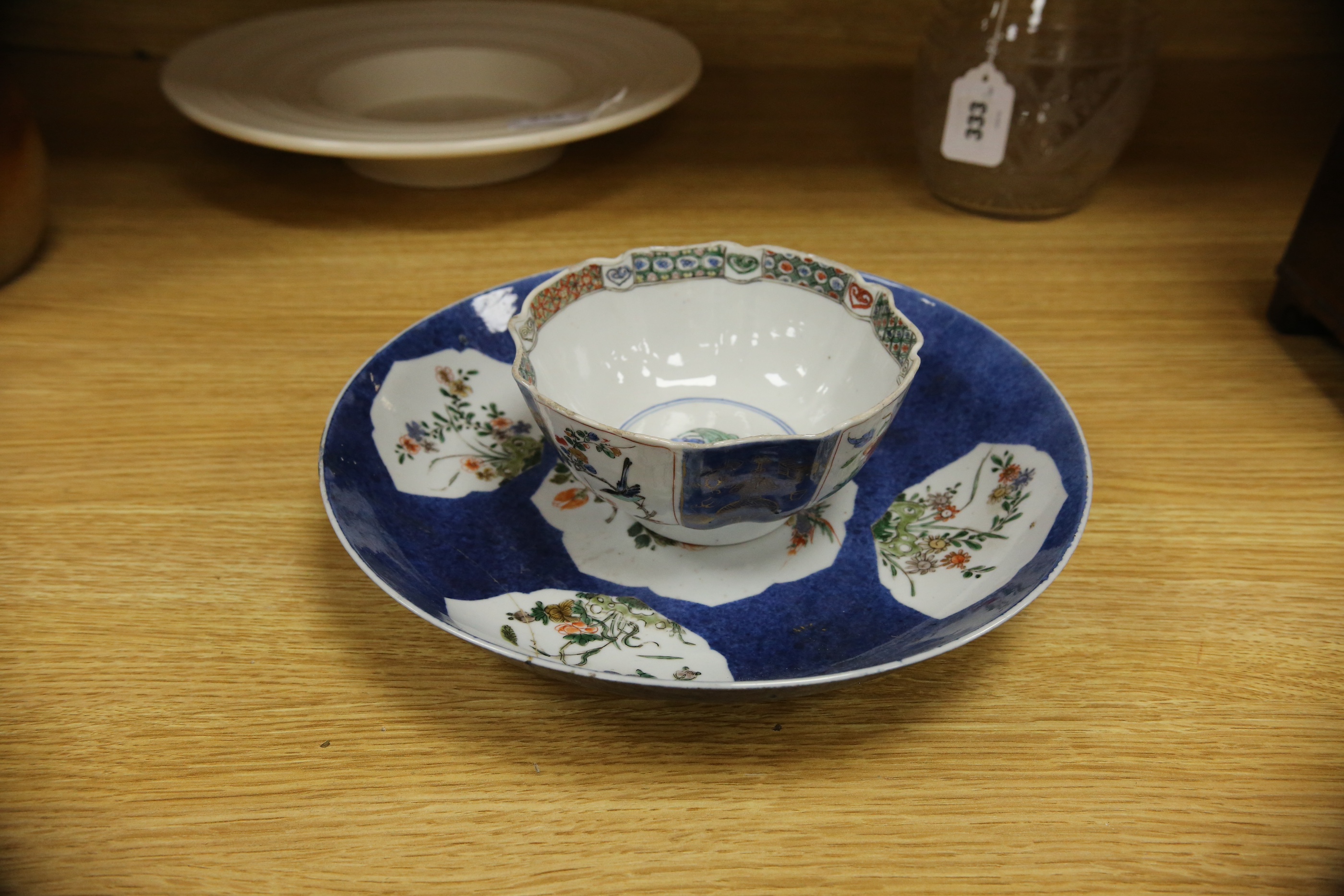 A Chinese famille verte powder blue ground bowl and a similar dish, both Kangxi period, 27.5cm diameter. Condition - dish poor, bowl fair